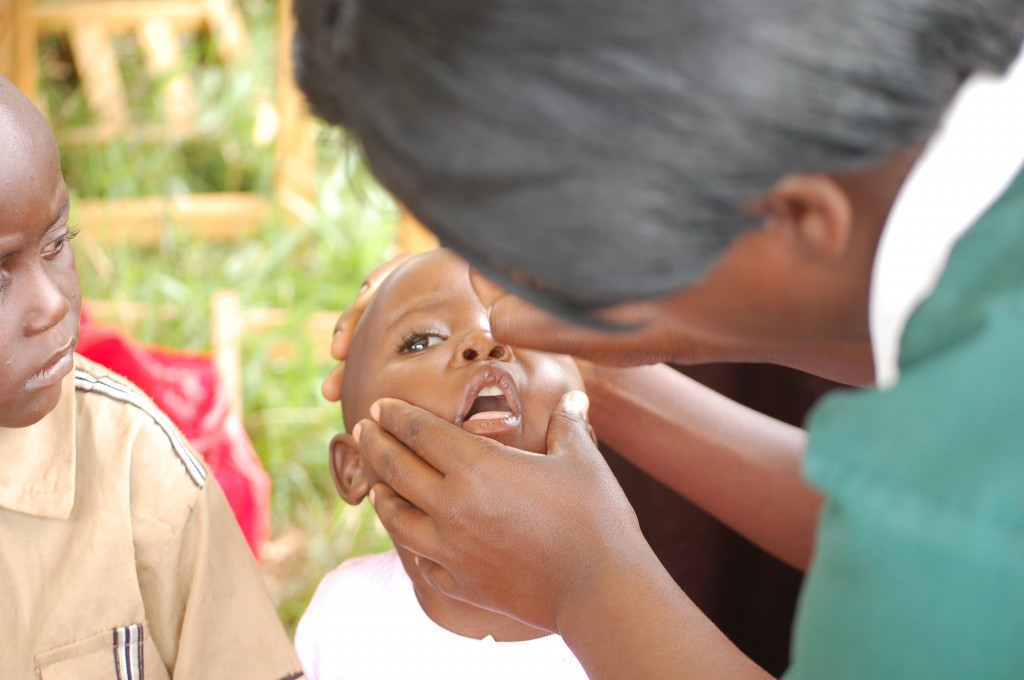 Child in Uganda getting a polio vaccine